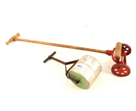 An English 'Knights head' alloy and steel childs garden roller plus a die cast childs lawn mower