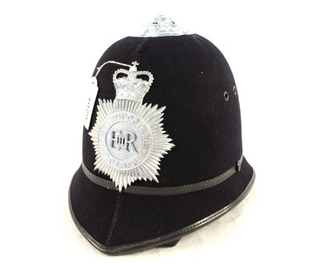 A Police helmet bearing Metropolitan Police insignia plate
