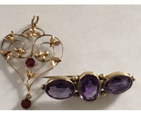 A 9 carat Gold pendent and a brooch set with three Amethyst coloured stones.