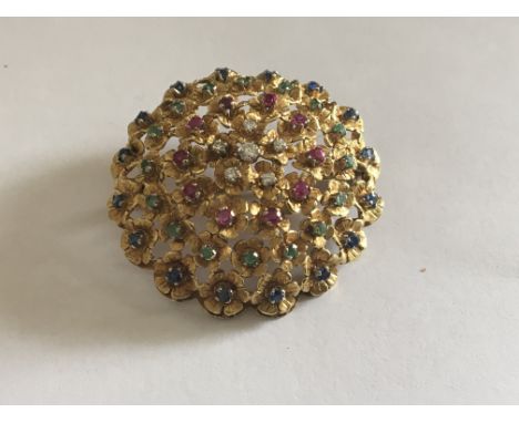 An 18 carat yellow gold brooch set with diamonds rubies Emralds and Sapphire.