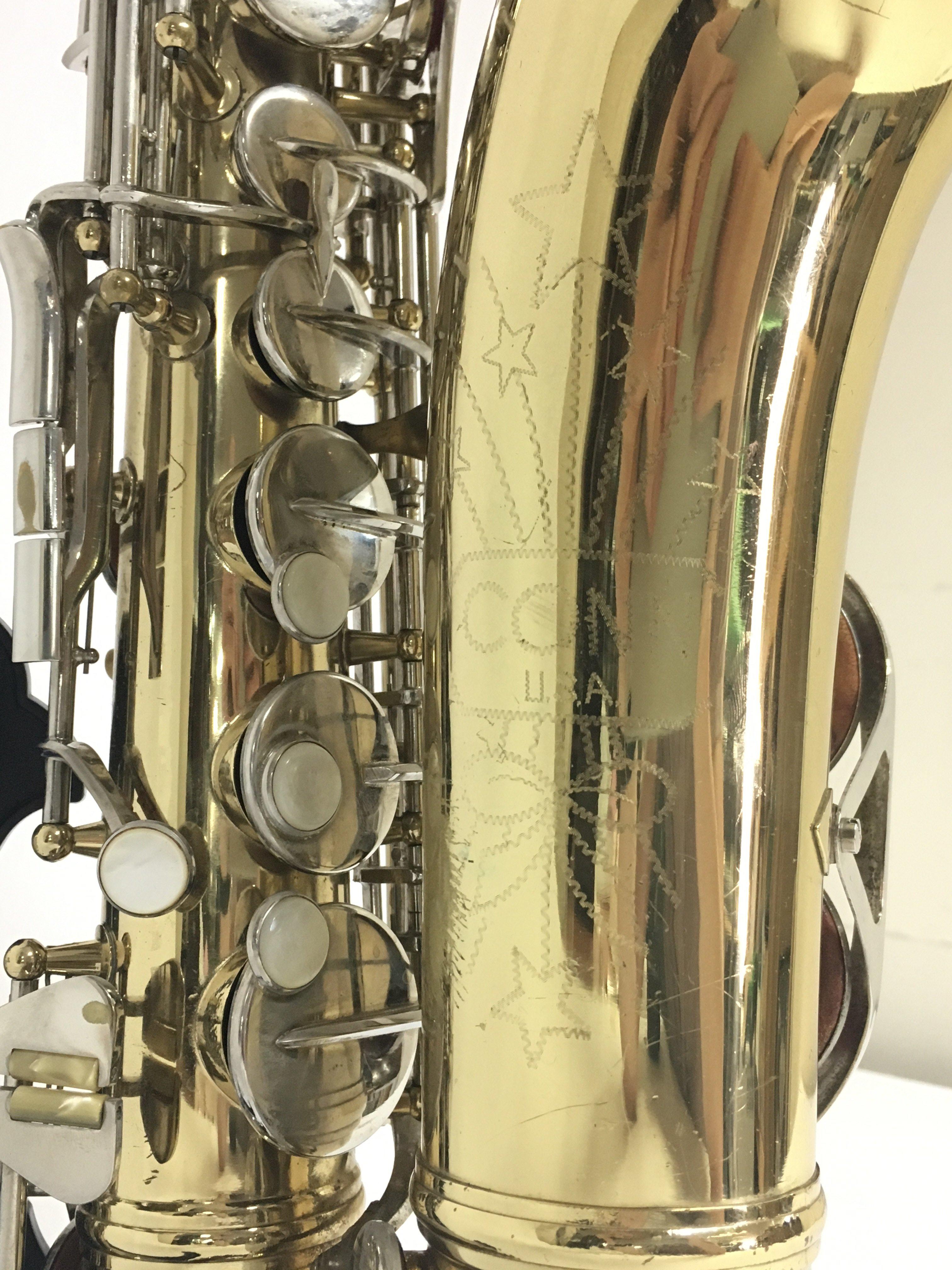 An American Conn saxophone engraved with stars, in a hard case.