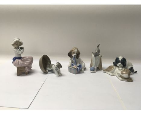 A collection of five mixed Nao and Lladro pieces to include Nao No. 1590 “Puppy playing” and Lladro No. 8312 “Can’t wait”