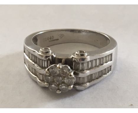 A 14 carat white gold ring of modern design set with diamonds. Ring size Q.