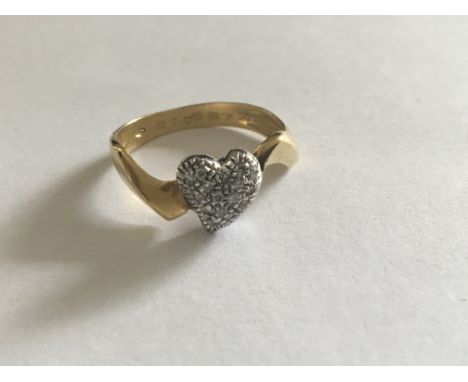 An 18 carat Gold ring set with a. Cluster of diamonds in a heart shape. Ring size P.