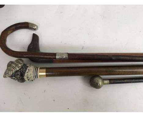 A A collection of three novelty walking sticks and a swagger stick