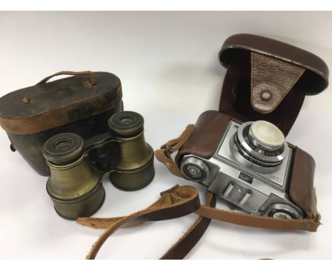 A pair of brass cased binoculars and a Zeiss Ikon camera (2).