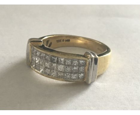 An 18 carat Gold ring set with three rows of Princess cut diamonds. Ring size O.