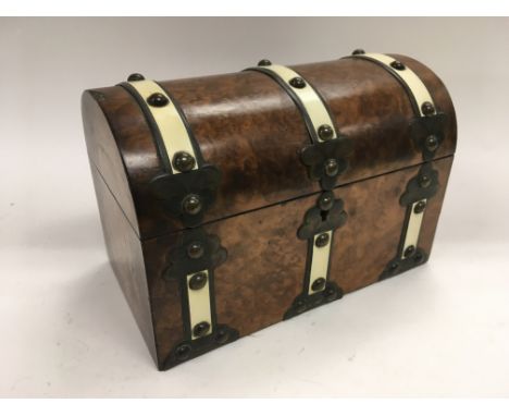 A dome topped walnut tea caddy.