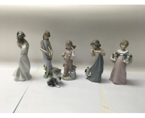 A collection of six Lladro figures to include No. 8106 “Naughty Puppy” and No. 7712 “Tulip Garden”