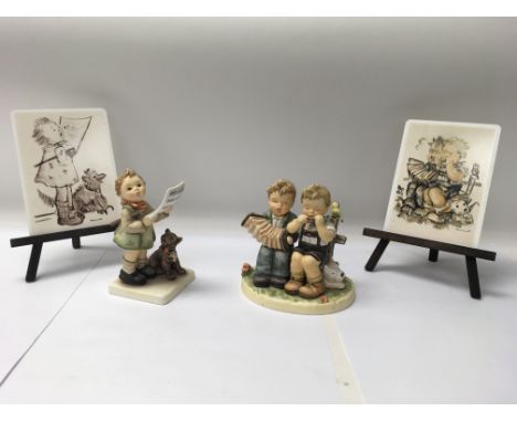 A pair of Goebel Himmel figures to include one of a child singing from a music sheet and the other of two children playing mu