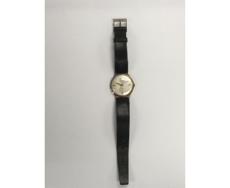 An Accurist 9ct gold cased manual wind wristwatch with a leather strap.