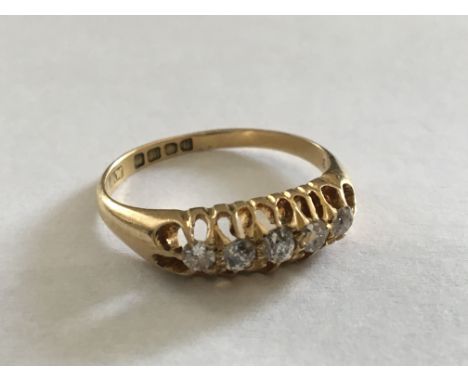 An 18carat gold ring set with a row of five diamonds. Ring size O.