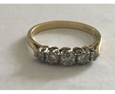 An 18 carat Gold ring set with a row of five graduating brilliant cut diamonds. Ring size O.