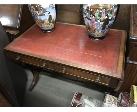 A reproduction sofa table with leather top.