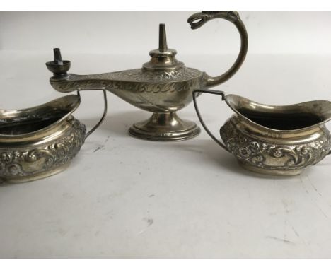 A silver lighter in the form of a lamp and a pair of silver salts