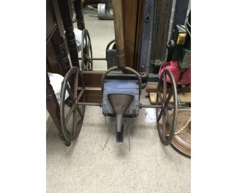 Vintage seeder on two iron wheels.