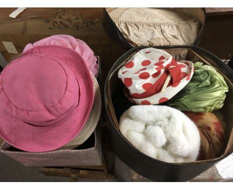 A collection of vintage hats with stand and hat box