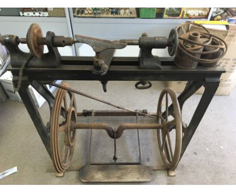 A late Victorian cast iron wood turning treadle lathe made by Kennan & Sons of Dublin Ireland possibly used on board a ship f