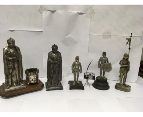 A collection of lighters mostly in the shape of knights and one lighter in the form of a camera