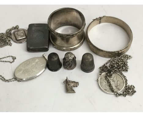 A collection of silver comprising Vesta thimbles bangle and pendants