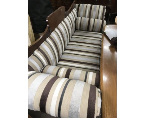 A Victorian upholstered mahogany scroll end sofa with striped upholstery.