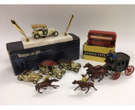 A collection of vintage toys including a boxed Budgie London bus, Lesney cars, lead cowboys and Indians etc.