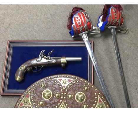 Two retrospective Wilkinson copy’s of Scottish swords, a battle shield and a copy of Napoleonien flint lock. (4)