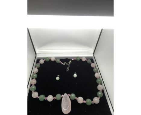 A boxed jade and rose quartz stone necklace and matching earrings