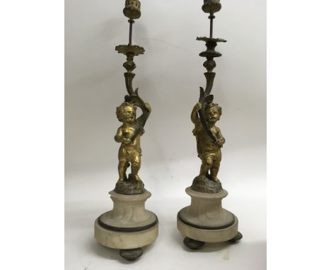 A pair of ormolu candelabra in the form of cherubs 47 cm