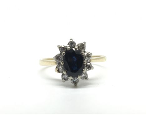 An 18ct yellow gold sapphire ring with diamond surround, total weight approx 2.5 grams.