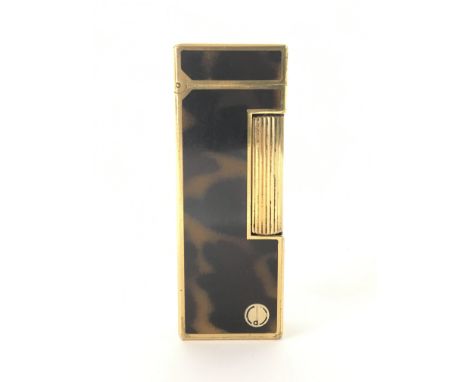 A Swiss made Dunhill lighter of gold tone with tortoiseshell style design.