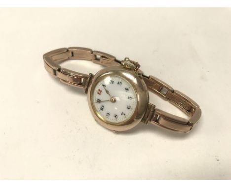 A vintage Swiss made ladies 9ct gold watch with 9ct gold bracelet strap and enamel dial. Working order. Weight approx 27.1g