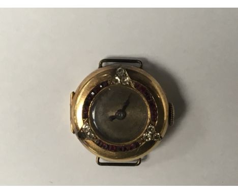 A Vintage Ladies Gold watch set with rubies and diamonds.