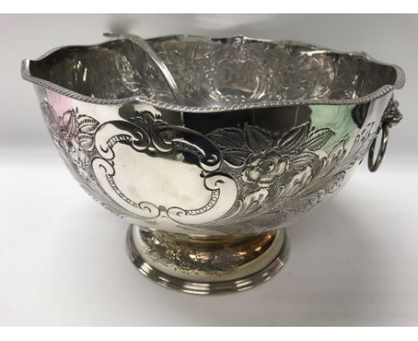 A silver plated punch bowl and ladle.