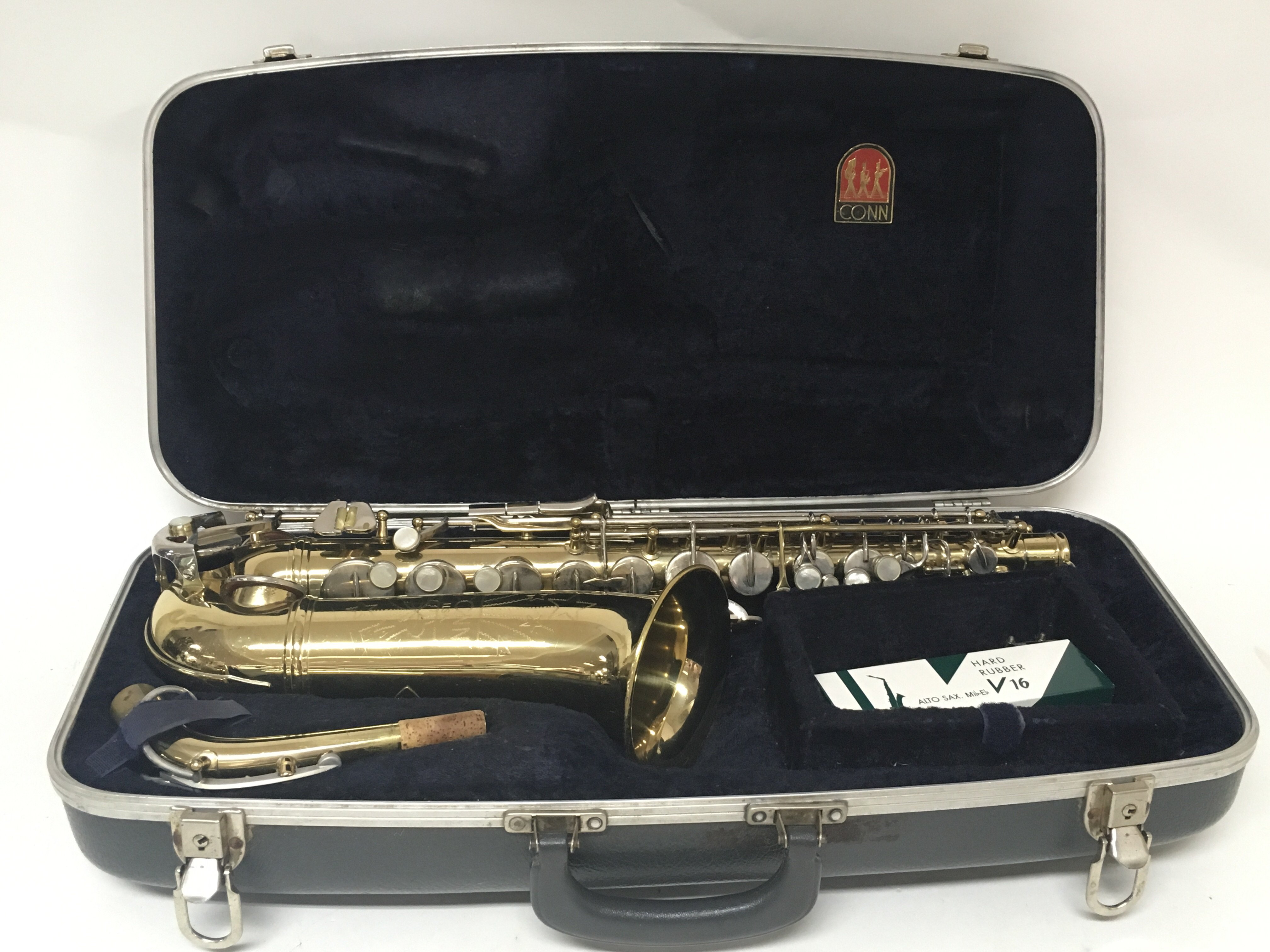 An American Conn saxophone engraved with stars, in a hard case.