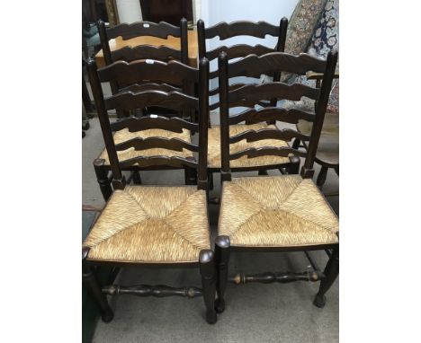 A set of four ladder back chairs.
