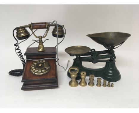 A set of shop scales with weights and a reproduction brass and wood telephone. (2)