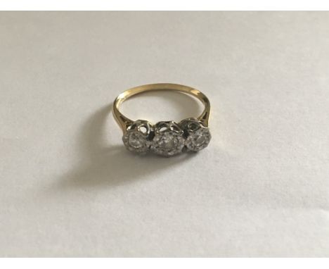 An 18 carat Gold ring set with three brilliant cut diamonds. Ring size M-N