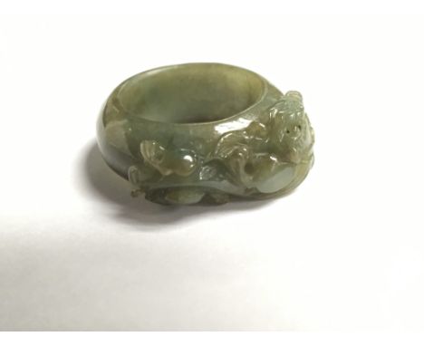 A carved and polished Jade ring in the form of a dragon. Ring size U.