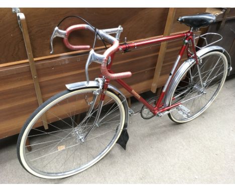 A 1954 James Arrow Ace bicycle.Red frame with silver lugs, three speed Sturmey Archer gears, Weimann brakes and front wheel, 