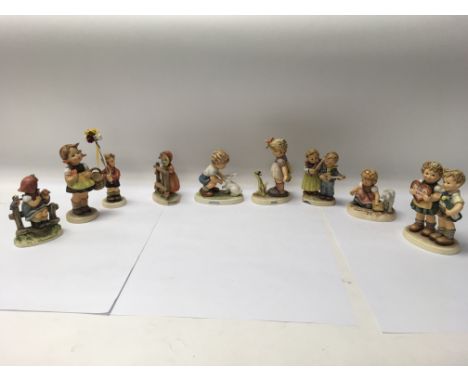 A collection of nine German Goebel Himmler figures, one with a chipped base