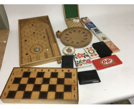 A collection of games and playing cards including a Bagatelle, Roulette game and a chess set