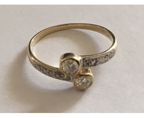 A 9carat Gold ring set with two diamonds the shank with further chip diamonds. Ring size O.