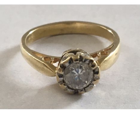 A yellow gold ring set with a brilliant cut diamond approximately .5 of a carat the mount set with smaller diamonds ring size