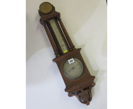 BAROMETER, Edwardian carved oak surround barometer with inset thermometer, 26" high