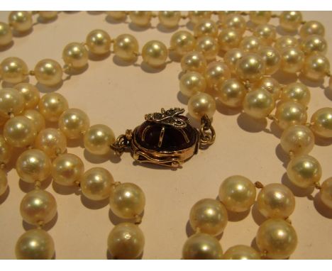 VINTAGE CULTURED PEARL SINGLE STRAND NECKLACE, with 15ct gold clasp, set with cabochon cut garnet with a fly sat a top