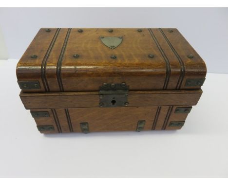 NOVELTY CIGAR BOX, an interesting Edwardian oak cigar box in the form of domed trunk with studding & shield presentation plaq