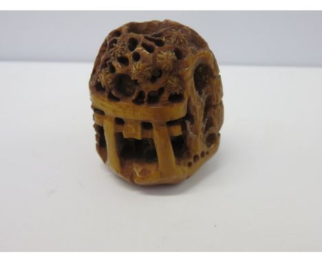 NETSUKE, a signed netsuke of village shrine 