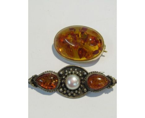 2 AMBER BROOCHES, one set in 9ct gold the other in silver