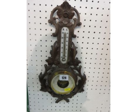 BAROMETER, an Austrian carved foliate framed aneroid barometer with inset thermometer